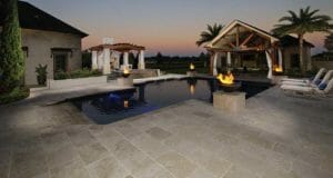 ivory travertine unfilled and tumbled outdoors around pool