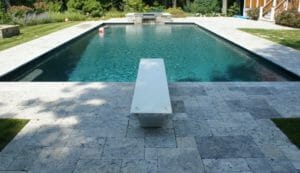 silver travertine french pattern unfilled and tumbled pavers and pool coping